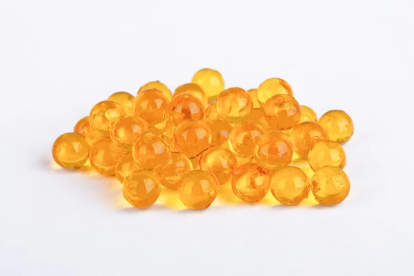 Gelbe Vitaminkapseln Stockbild