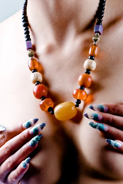 stock image Amber necklace and artistic manicure
