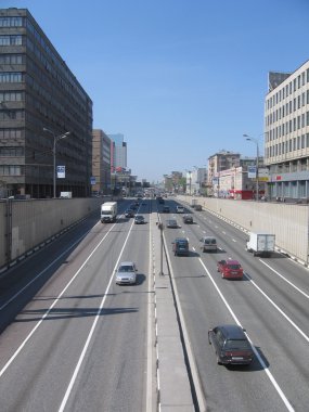 Moscow road.Bilateral Moscow road with some cars at sunny day clipart