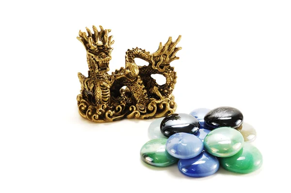 Metal dragon and a pile of colore — Stock Photo, Image