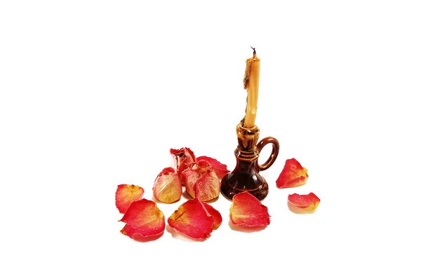 Зажженная свеча и сухая роза с лепестками — стоковое фото