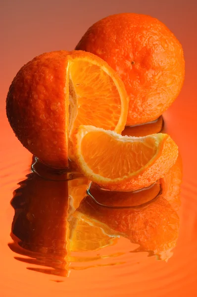 stock image Wet orange on mirror