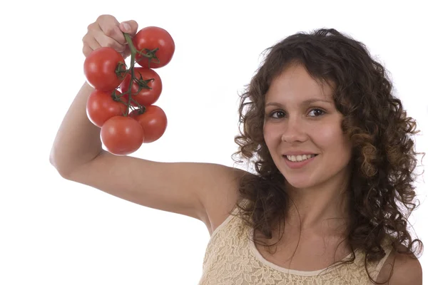 Frau hält Tomatenzweig — Stockfoto