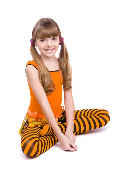 Little girl wearing orange dress — Stok fotoğraf