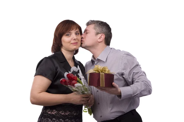 Мужчина дарит подарок и целует женщину . — стоковое фото
