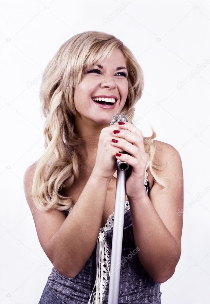 Singer. Girl singing into microphone.
