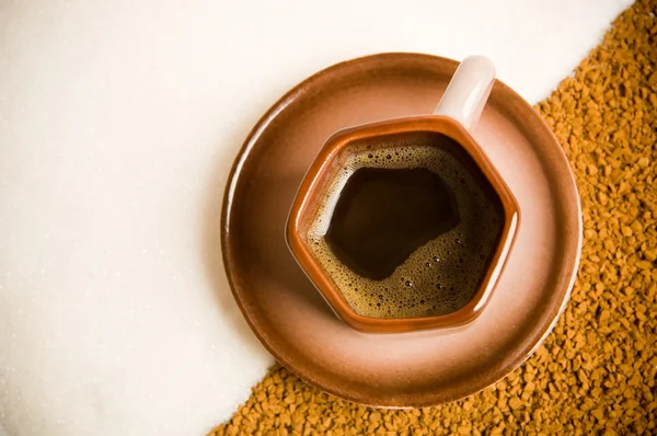 Cup of coffee on coffee grounds — Stock Photo, Image