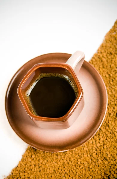 Cup of black coffee on coffee grounds — Stock Photo, Image