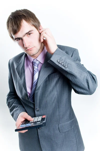 Serious looking businessman with calcula — Stock Photo, Image