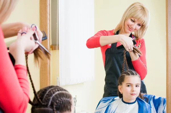 Pretty little girl in hairdresser salon Stock Photo