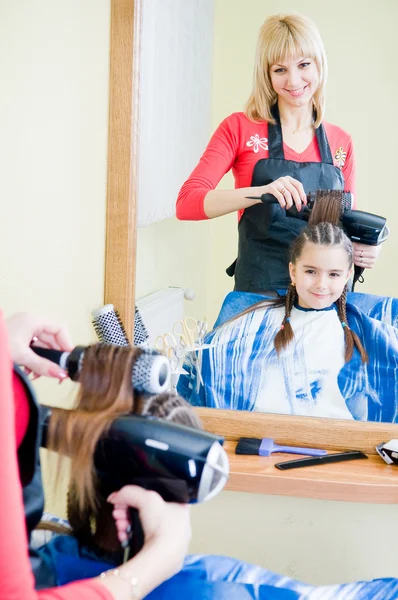 Little girl in hairdresser salon Stock Image