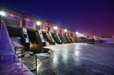 Night view of a dam clipart