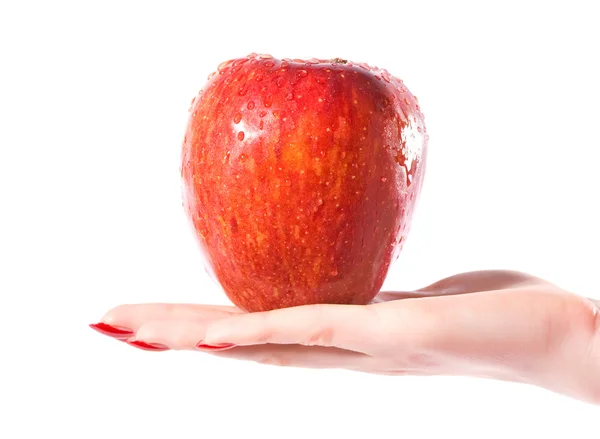 Woman hand with wet red apple — Stock Photo, Image
