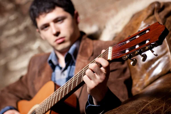 stock image Young man playing on guitar