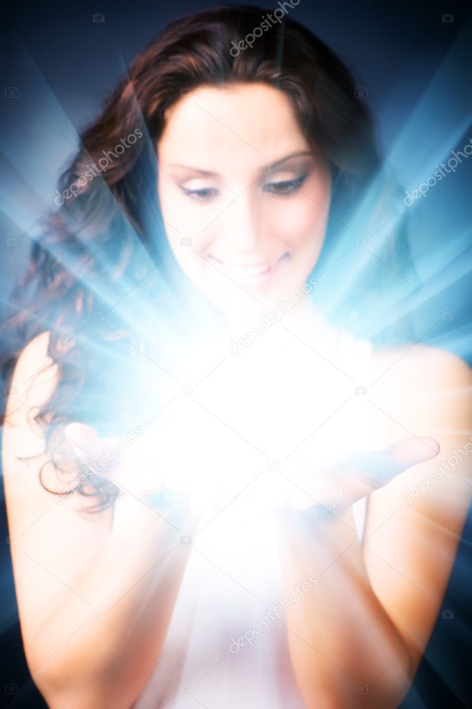 Young woman with magic shine in hands