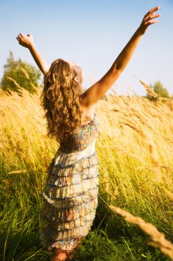 Young woman in a summer field clipart