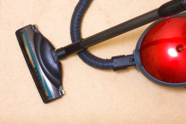 Vacuum cleaner on a carpet clipart