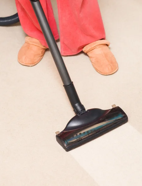 stock image Housewife vacuum a carpet