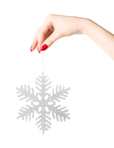 Woman hand holding big holiday snowflake — Stock Photo, Image