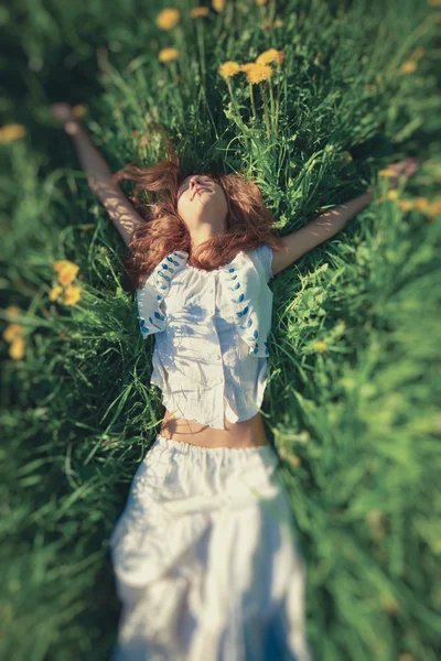 Fiatal nő feküdt a fűben — Stock Fotó