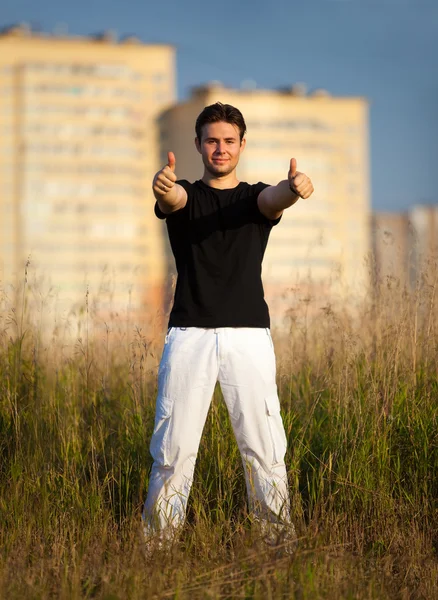 Young man showing success handsign — Stock Photo, Image