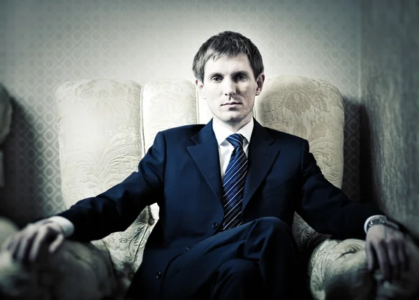 Young businessman on a chair — Stock Photo, Image