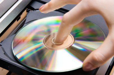Insert CD into player clipart