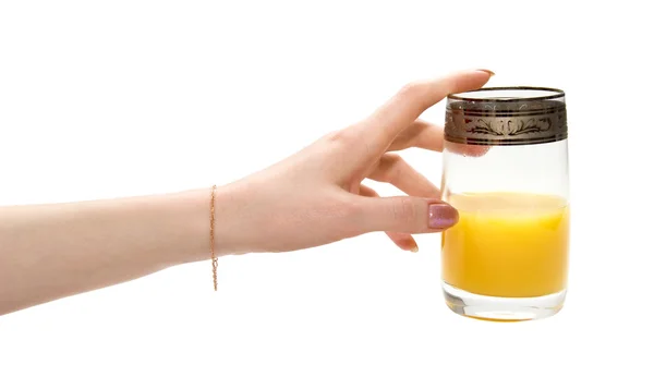 Hand stretching to glass of juice — Stock Photo, Image