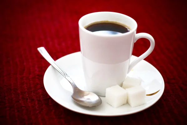 stock image Cup of coffee on red background