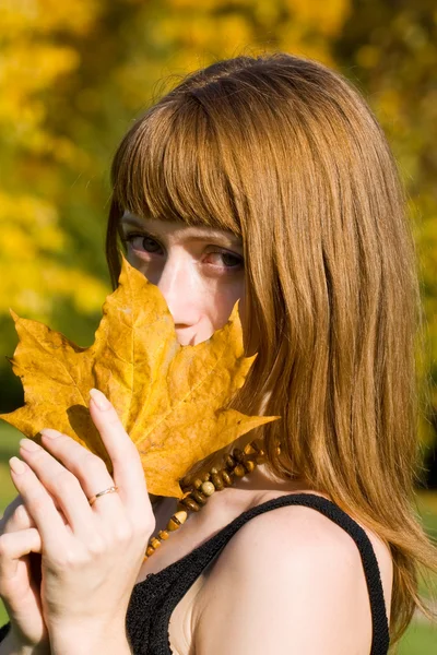 Girl with maple leaf — Stock Photo, Image