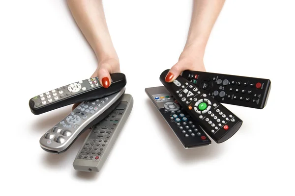 Vrouw handen met tv-afstandsbedieningen — Stockfoto