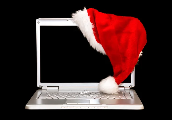 Silver laptop med santa hatt — Stockfoto