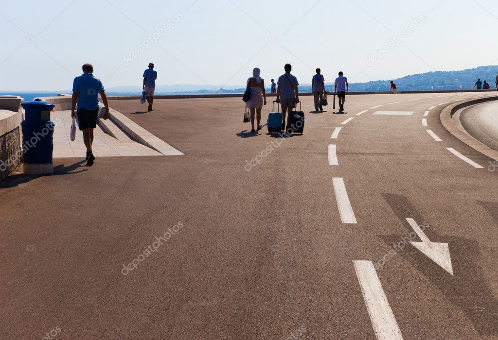 Walking tourists on a big road