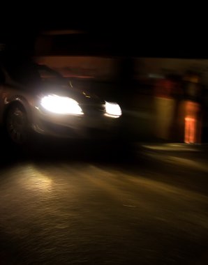Fast moving car at night clipart