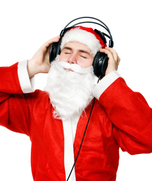 Санта-Клаус слушает музыку — стоковое фото
