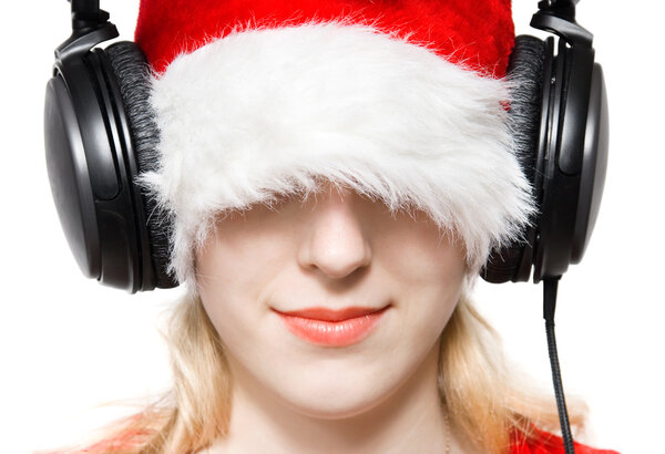 Young woman in santa hat listening music