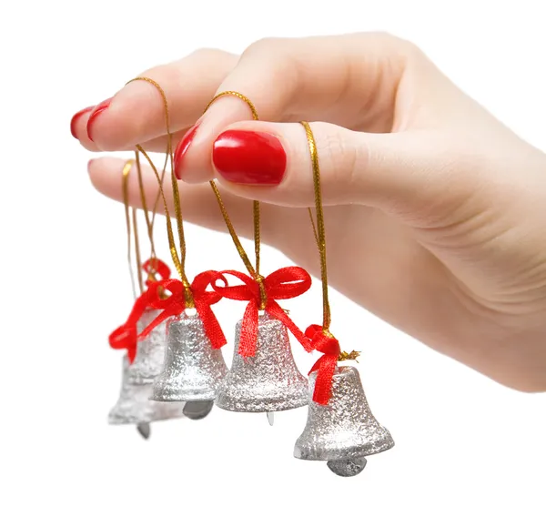 Woman hand with small bells on fingers — Stock Photo, Image