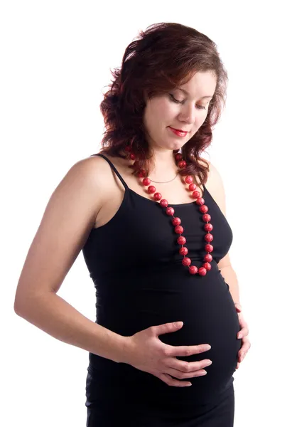 Беременная женщина в черном платье — стоковое фото