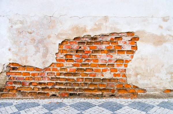 Кирпичная стена с большой вмятиной — стоковое фото