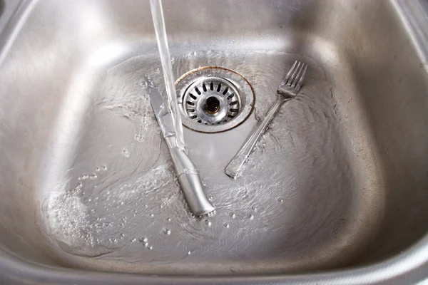 Metallic kitchen sink with water — Stock Photo, Image