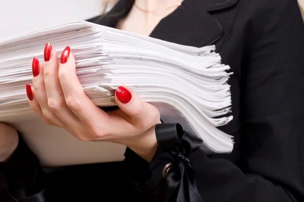 Businesswoman with heap of papers — Stock Photo, Image
