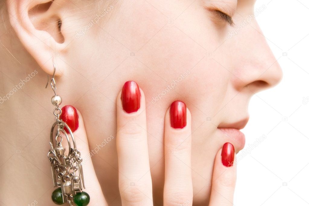 Young woman face and hand with red nails