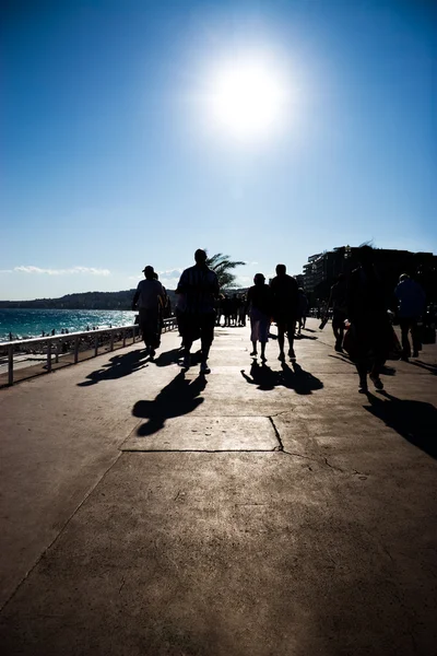 stock image Walking silhouettes on sea coast