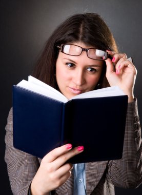 Young school teacher reading a book clipart