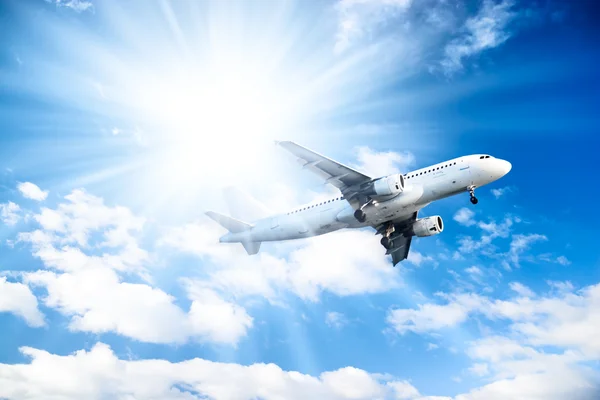 Airplane on blue sky background — Stock Photo, Image