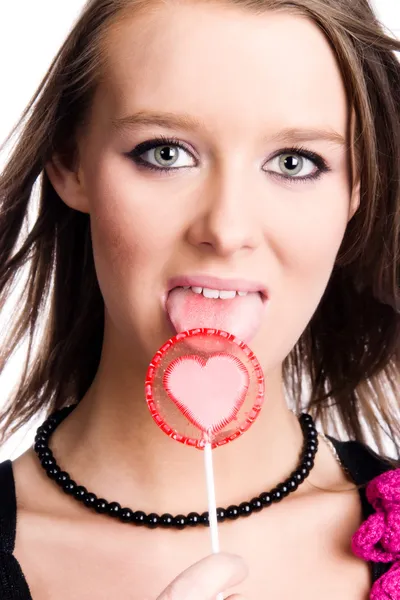 Young woman licking lollipop — Stock Photo, Image