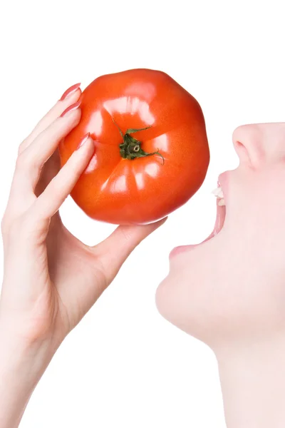 stock image Young woman biting tomato