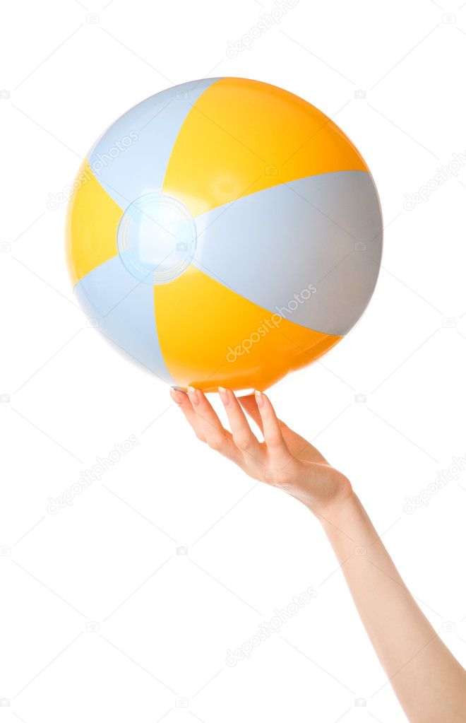 Woman hand with beachfront ball