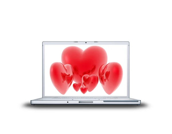 Red hearts on laptop screen isolated on — Stock Photo, Image