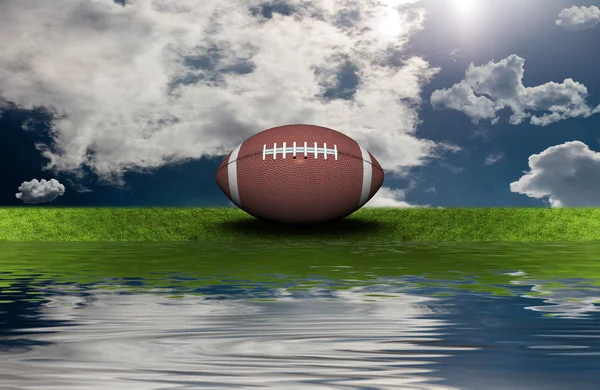 Футбол на зеленій траві зі спиною неба — стокове фото